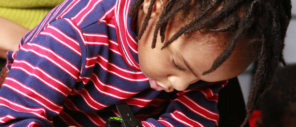 A happy child engaged in creative play at US Academy in Houston