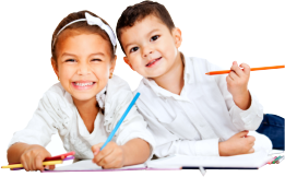 Two smiling preschoolers drawing together at US Academy